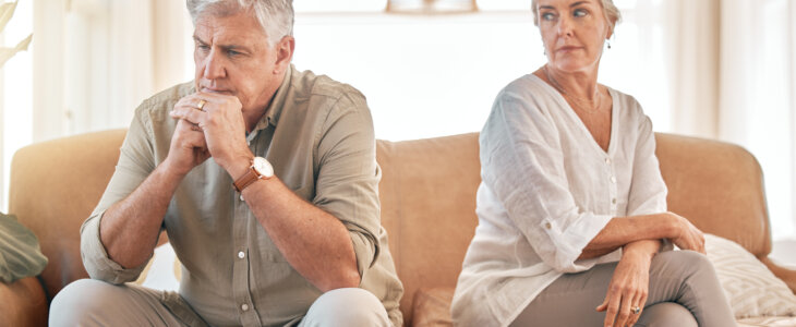 Senior couple, divorce and disagreement in conflict, fight or argument on living room sofa at home. Elderly woman and frustrated man in depression, cheating affair or toxic relationship in the house