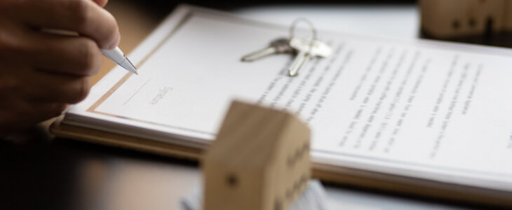 lawyer signing a contract for a purchase agreement mortgage and rental housing.