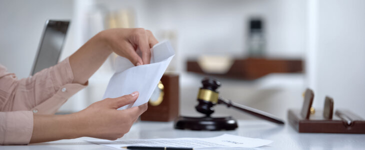 Divorced woman holding envelope with alimony, savings for single mom, allowance