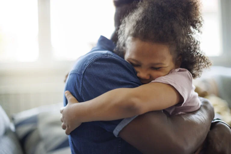 Guardian and child hugging